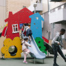 big playhouse with slide coming out of the side window