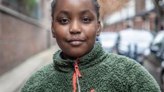 Akiira, 10, stands for a portrait in a Peabody Estate in London, UK.
